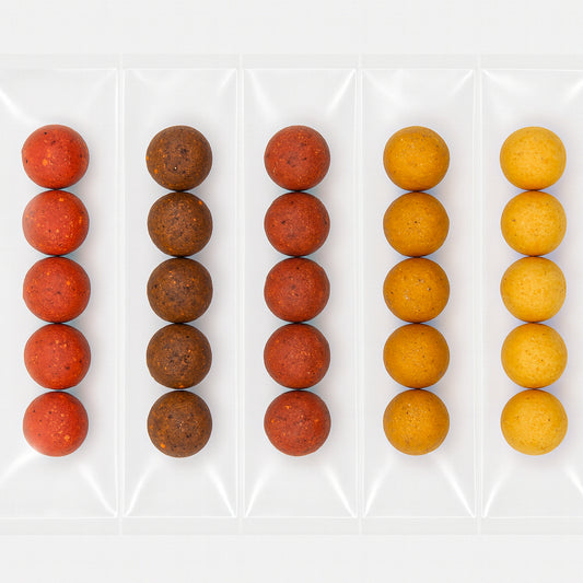 Sample pack of boilies in five flavours, neatly sealed in individual compartments of a clear vacuum pack against a white background.